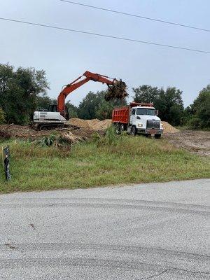 Hauling in dirt from our pit and hauling off debris to our vegetation yard. Charlotte county.