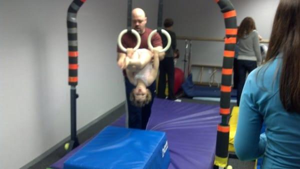 Doing a flip on the rings in Busy Bees class