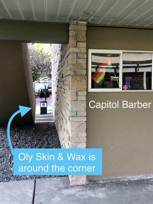 Oly Skin & Wax is behind the barber shop, just look for the planter with sign and walk around the corner!