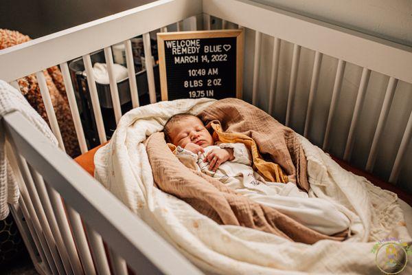 In home newborn session sharing baby's details.