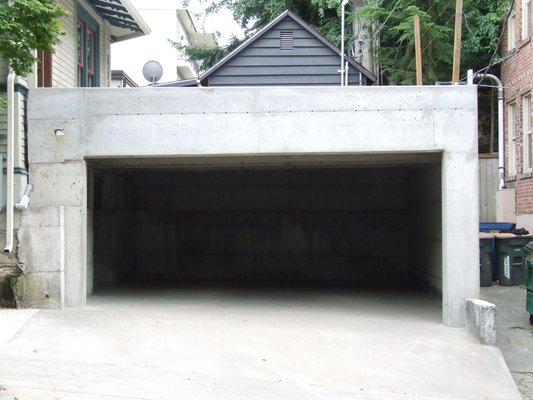 Concrete garage with walking deck/patio above