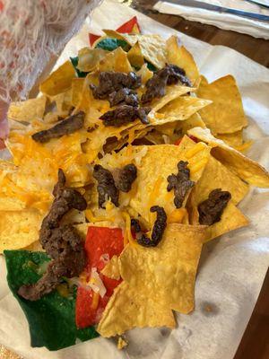 The nachos- I would assume nachos would have more cheese, and it would be melted.