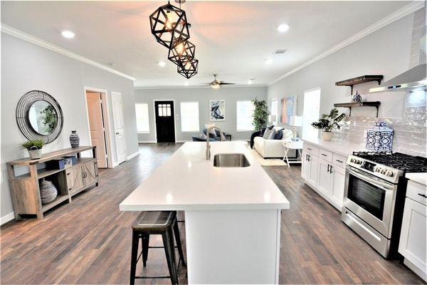 White kitchen design with black accent accessories.