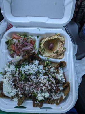 Lamb and chicken gyro meat over delicious rice with a side of hummus and a fun little salad