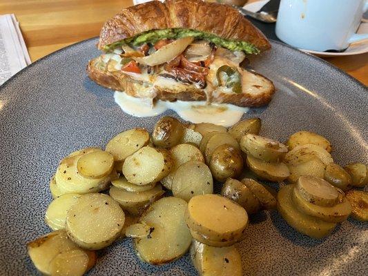 The Rancher sandwich on croissant with confit potato hash.