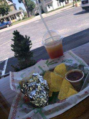 Chicken burrito and a strawberry mixed with some mango slushy.