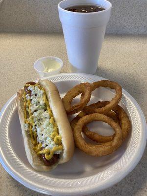 Beef hotdog with coleslaw and mustard, onion rings and an unsweet tea