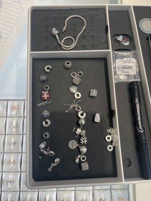 Staff disassembled the entire charm bracelet, cleaned it and reassembled it.