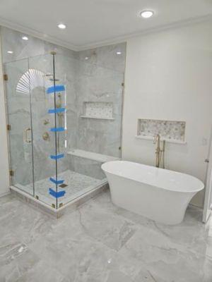 Demoed original 80's shower and tub. Built new shower, installed new free standing tub, installed new flooring. It came out beautiful.