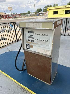 A view from the outside dining area showing one of the former gas pumps.