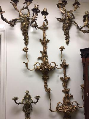 Antique sconces in singles, pairs, and larger sets.