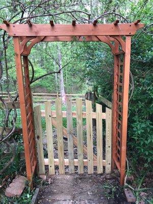 Wood gate with arbor by Lions Fence