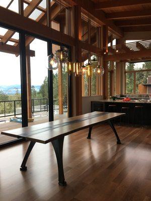 Blackened steel "I-beam" table. Live edge White Oak. Amazing setting for a well executed project.