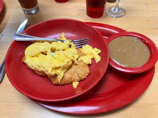 Spicy biscuit, scrambled eggs, and brown gravy