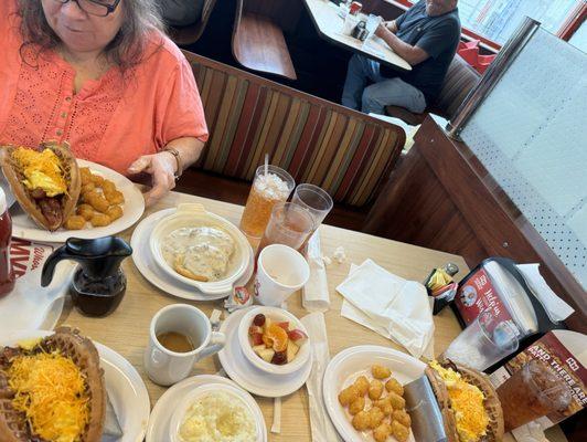 Here we have the bacon, waffle, taco, and our sides. There was the biscuits and gravy, The cup of fruit and then the grits