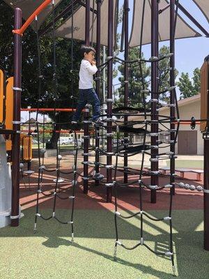 New playground area with rubber floor and this rope wall to get to another slide