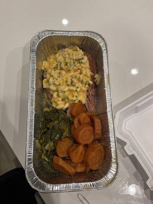 Stuffed turkey leg with mac & cheese, yams, and greens