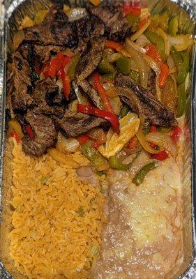 Beef fajitas served with tortillas, rice n fried beans