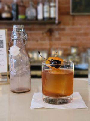 Smoked old fashioned (served in carafe with smoke inside, see before image)