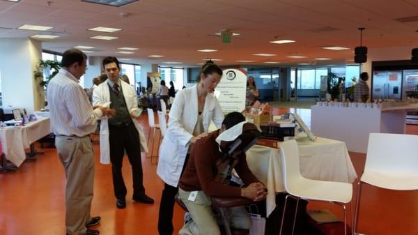 Abundant Heaven providing information & mini-massages at a corporate health fair in downtown San Jose.