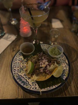 Birria taco with a passion fruit margarita