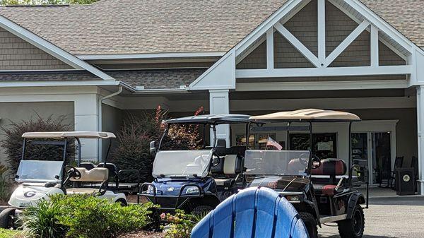 A busy place with golfers in and out with their golf carts.