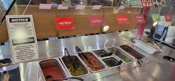 Close up on the condiment bar at Taco Bueno.