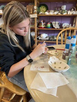 Working on her olive bowl