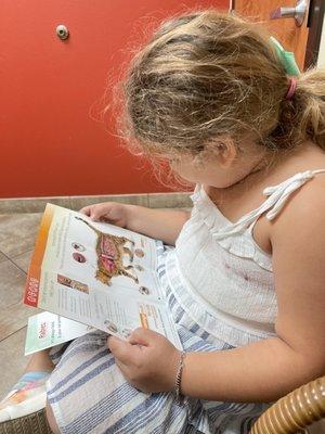 Ru-pee's best buddy (our granddaughter) reading about cats.