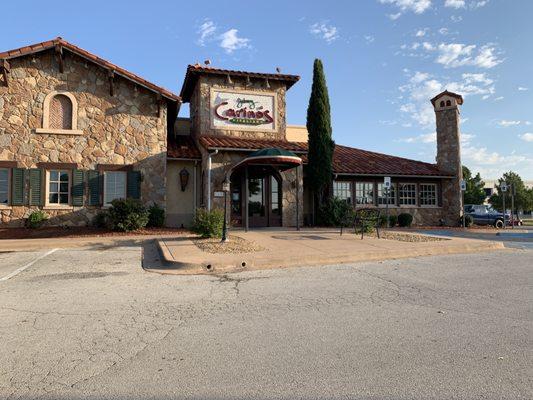 Front view of Johnny Carino's, highlighting their stone wall pattern and elegant outdoor design to make it stand out.