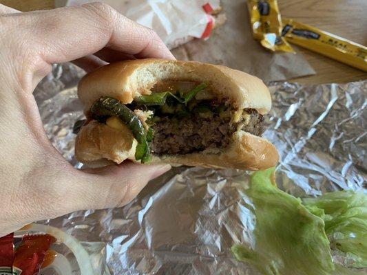 Cheeseburger with grilled jalapeños, lettuce, and raw onion