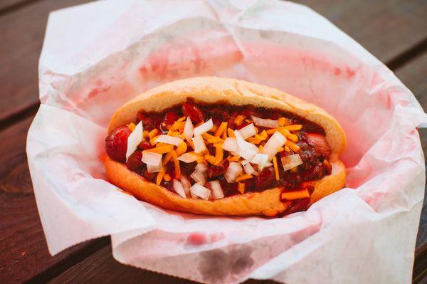 Our chili dog starts with a smokey grilled all-beef dog on your choice of Italian roll or Pretzel bun, topped with our housemade chili, che