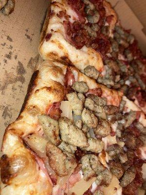 Deep dish, side view. Pepperoni bacon and sausage/ ham pina and sausage