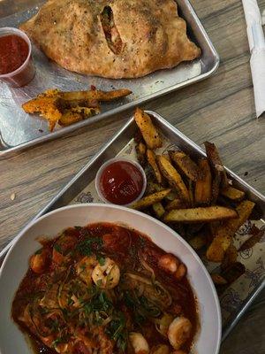 Shrimp zucchini noodle pasta and a calzone