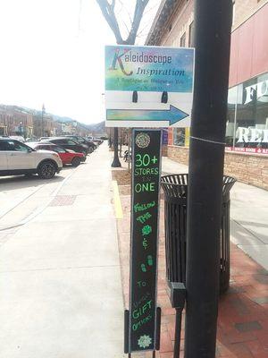 Sign on corner of 5th and Main in Canon City pointing the way to our store