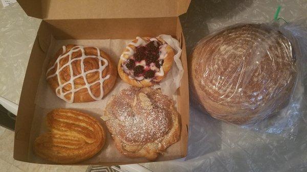 Blackberry Danish, almond croissant, elephant ear, cinnamon bun, and whole wheat sourdough bread.