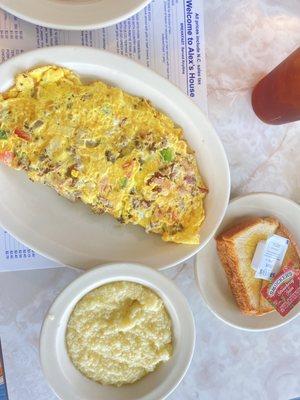 Bacon and Sausage Omelette with Grits and White Toast.