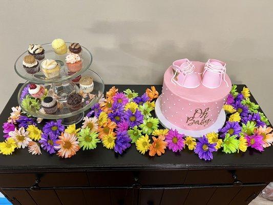 Mini cupcakes and 8 inch cake on display at a baby shower