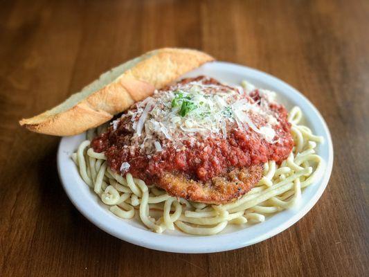 Chicken Parmesan. Hand-breaded with our walnut, garlic and parmesan breading, baked and served over handmade spaghetti with marinara.