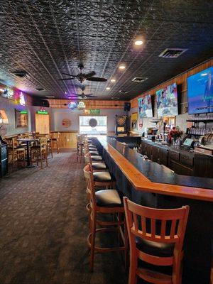 indoor bar seating and televisions