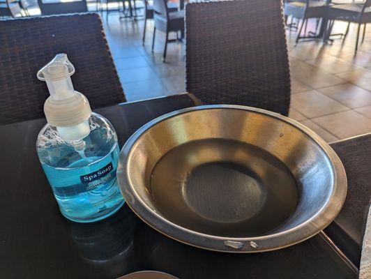 Bowl and soap to wash hands after using hands to eat fufu dish.