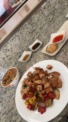 Sesame chicken, egg roll and sauces.