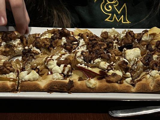 This flatbread pizza was the best I have ever had anywhere. Cheese, walnuts and balsamic drizzle on a layer of apples thinly sliced.