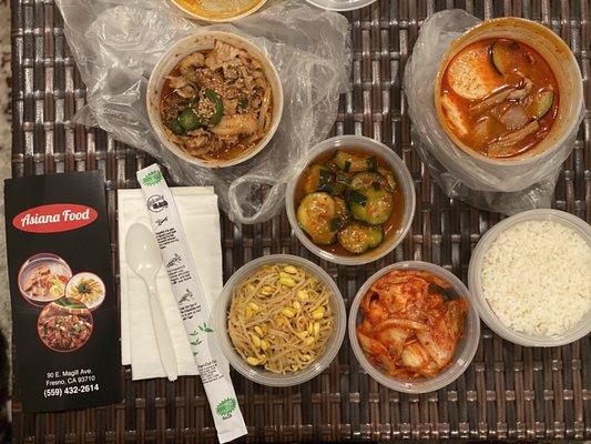 My takeout order: Soft tofu soup (soondubu), spicy pork, rice, and side dishes (banchan) of kimchi, bean sprouts and cucumber kimchi