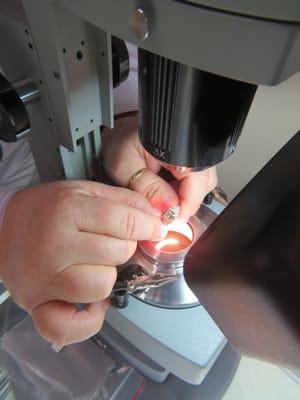 Diamond ring being assessed.