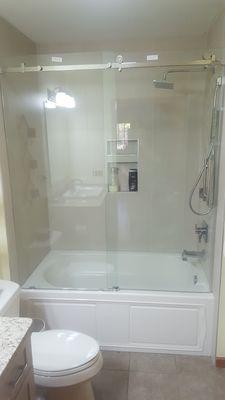 Sliding shower enclosure on bathroom tub