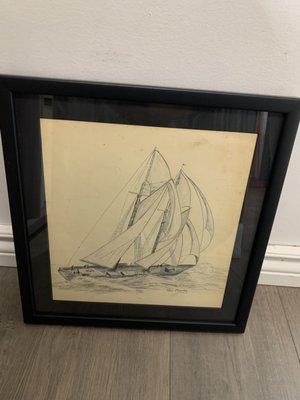 Drawing of a ship with a black matting and a classic black frame. This drawing is using an acrylic non shatter glass.