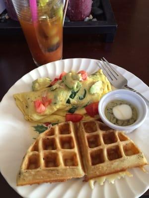 Fresh made vegetable omelet with smoked salmon, avocado and waffle.