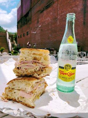 Muffaletta sammy by chef Antonio Mora of Russell's in Bovina, NY + a refreshing Topo-Chico in the courtyard at This and That.