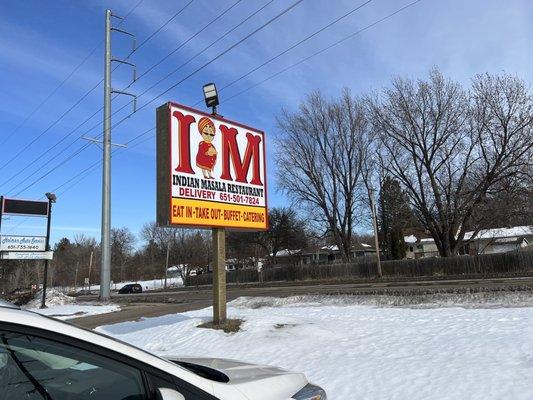 Sign from the street. If you blink, you'll miss this place. Kind of weird location. Next to an auto part and flower store